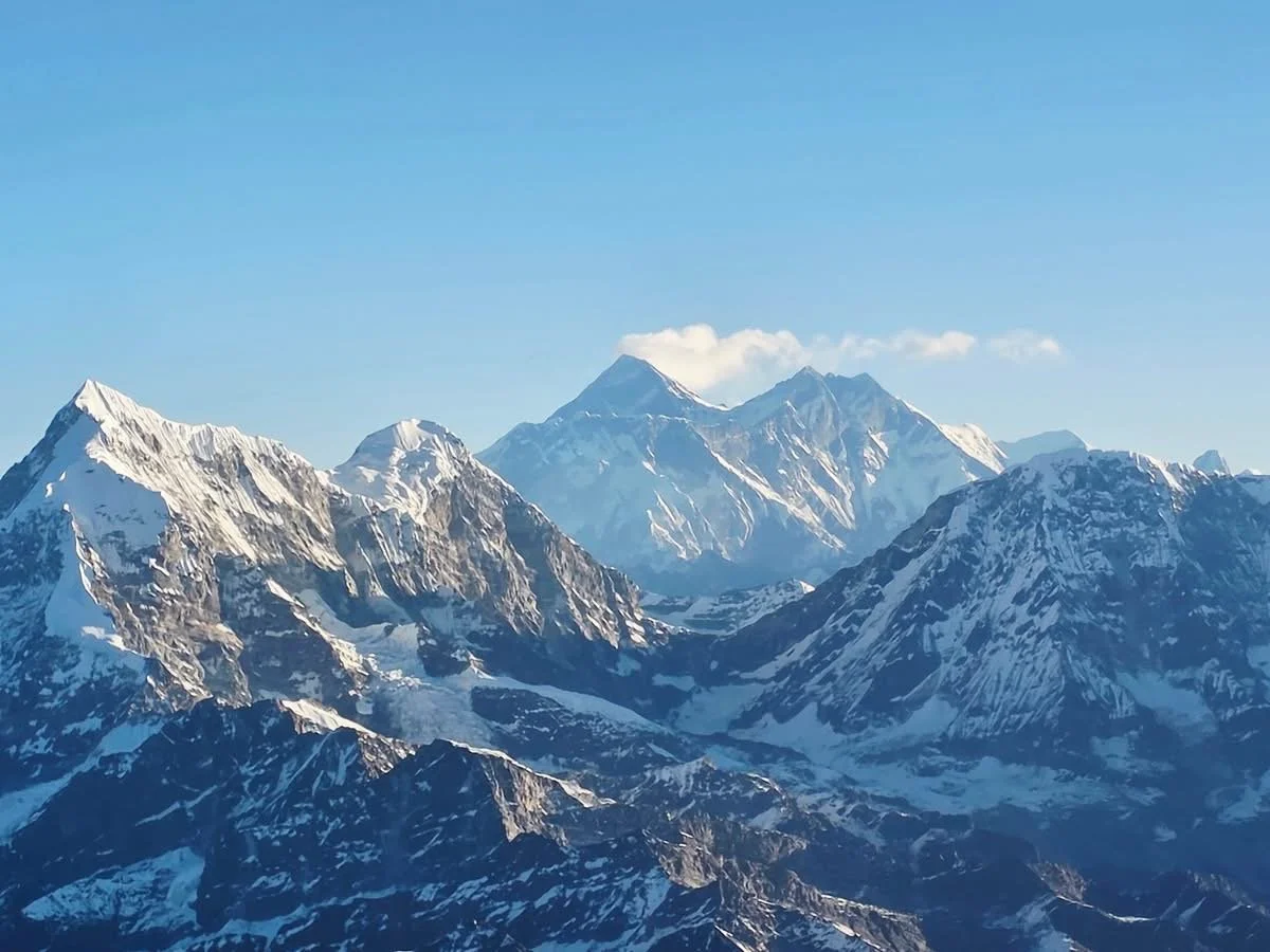 Snow-capped mountain range under a clear blue sky.
