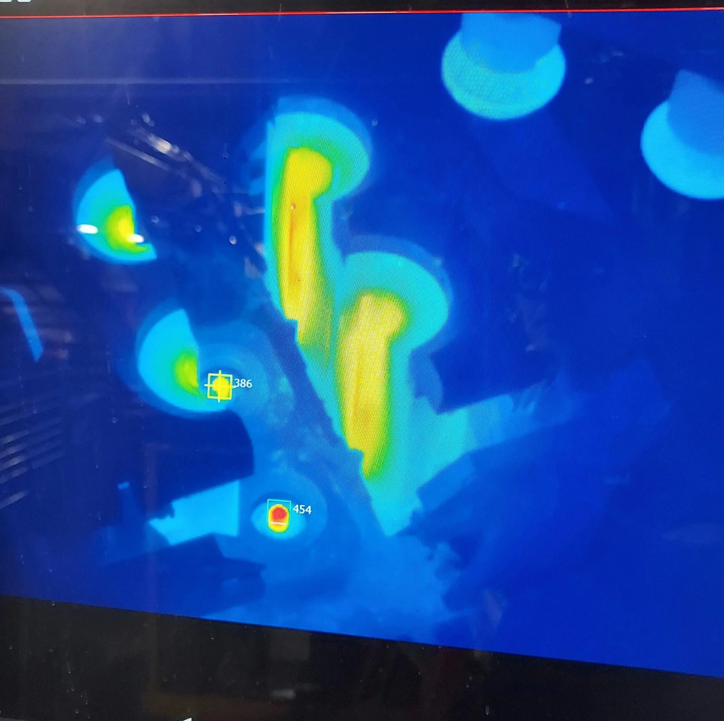 Cortex Infrared thermal image showing blanks ection on an IS machine, with two prominent yellow and red heat spots and several blue cooler areas.