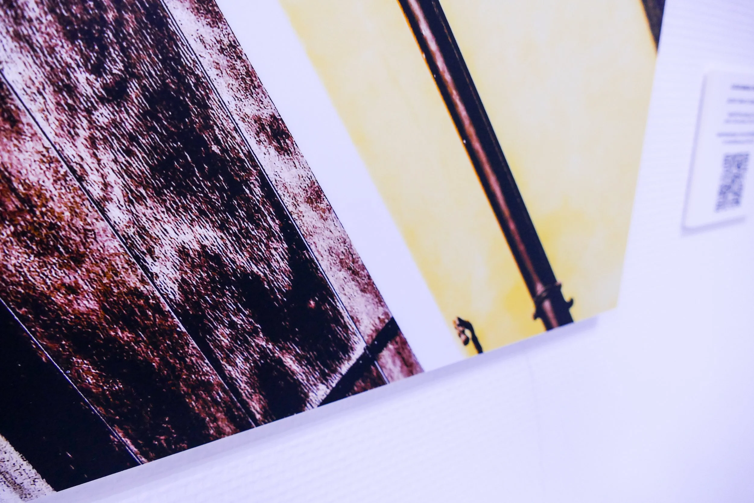 Nahaufnahme eines Drucks mit einem Bild, das einen Pfosten zeigt, vor einem gelben Hintergrund. Das Bild ist teilweise zu sehen.