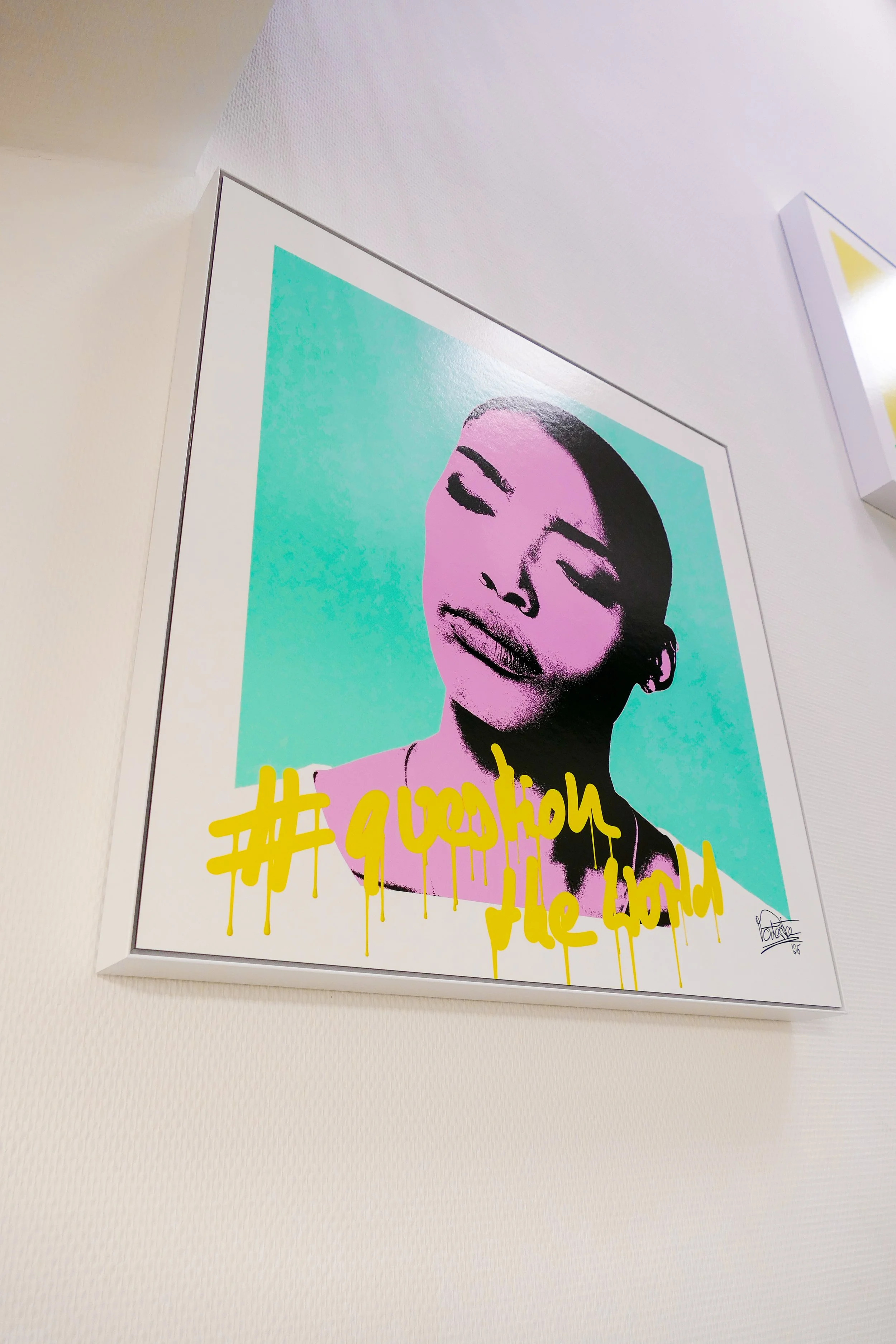 Ein modernes Kunstwerk eines lächelnden Gesichters in Graustufen auf einem pink-blauen Hintergrund mit gelber Graffiti-Aufschrift, signiert mit 'Vonne'.