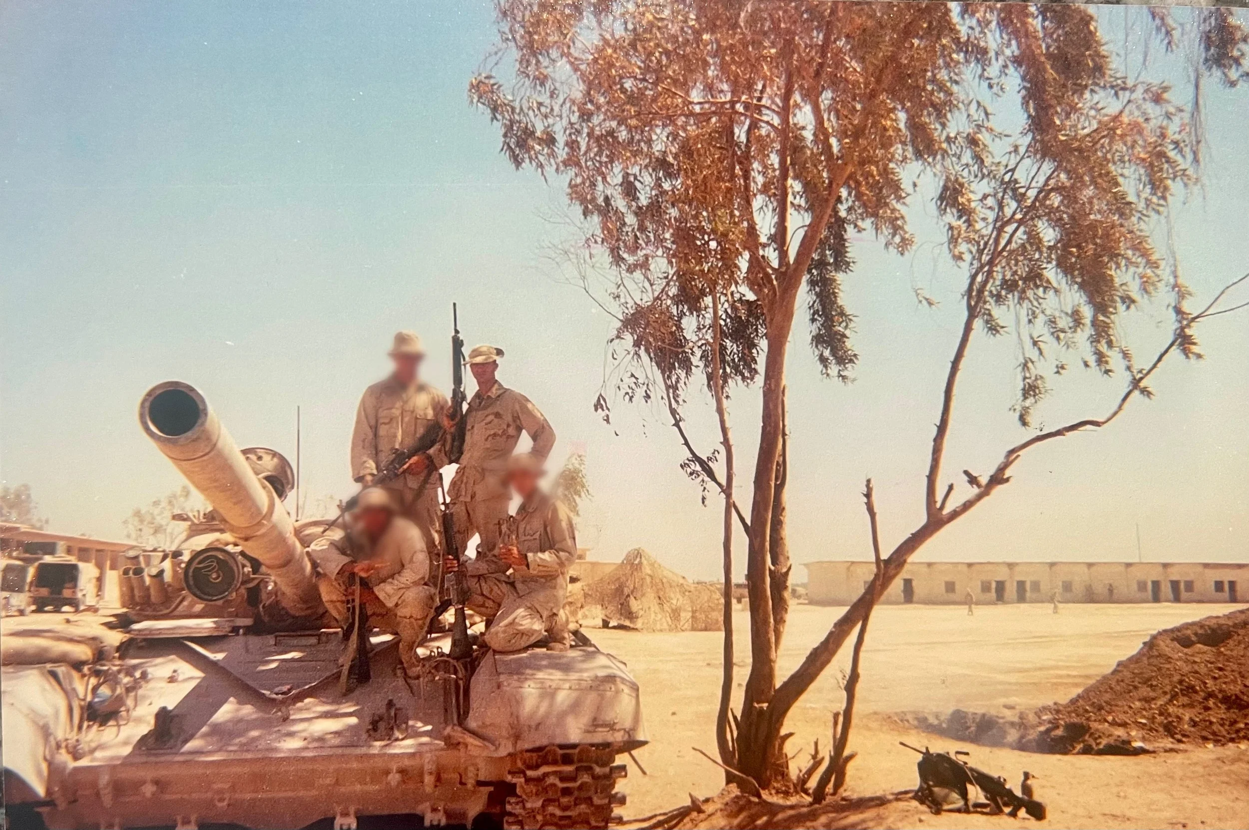 Marine veteran on tank in desert