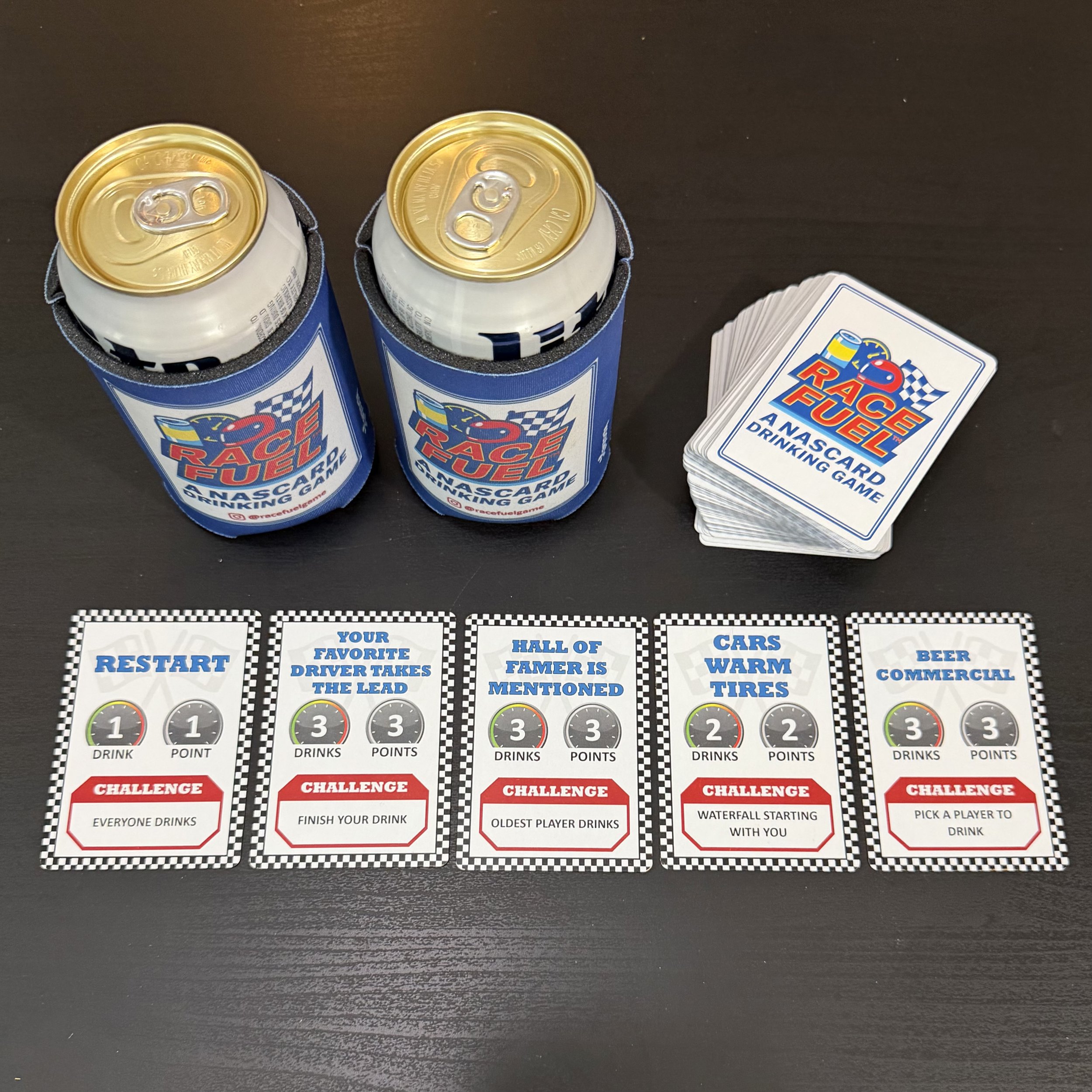 Race Fuel challenge cards displayed with the game deck and can sleeves, showing player actions for live race card game gameplay.