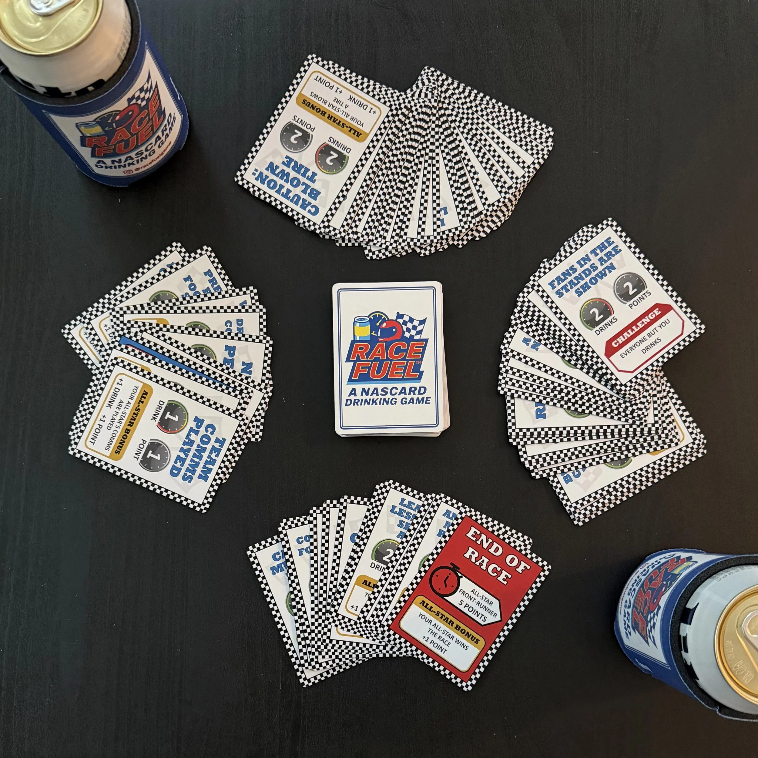 Race Fuel card game layout with card piles, can sleeves, deck, and End of Race card for live racing gameplay.