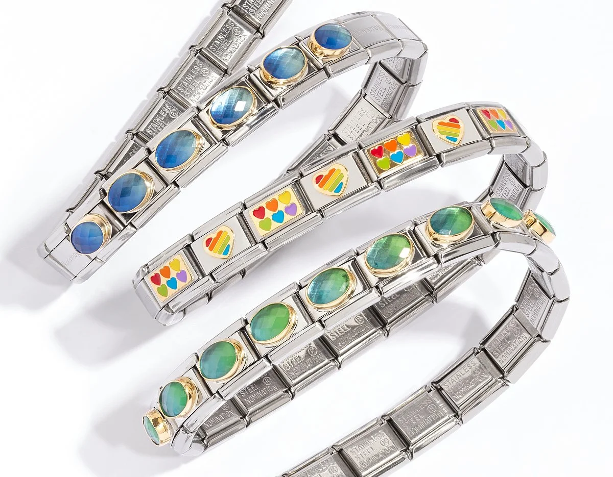 Three Nomination Italy Composable Charm bracelets with colorful stone and enamel designs, arranged on a white background.