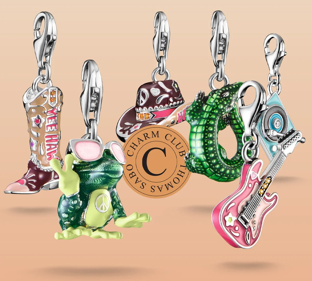 Collection of colorful Thomas Sabo enamel charms including cowboy boots, a frog, a peace sign, a snake, a guitar, a cowboy hat, and a speaker, with a central round charm with a C and the words "Charm Club" around it.