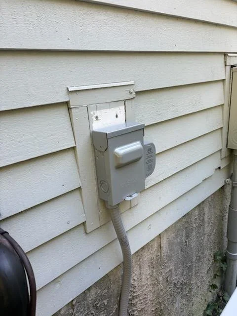 Exterior disconnect and conduit for a new condenser circuit installed by Innis Electric in Natick, MA on September 11, 2026.