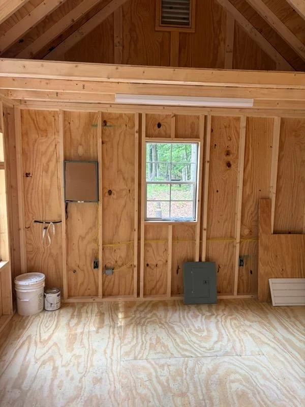 01-shed-interior-rough-electrical-panel.jpg