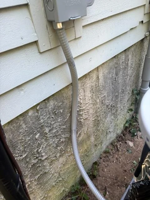 Condenser circuit wiring and weatherproof conduit installed for a Natick, MA residential HVAC project on September 11, 2026.