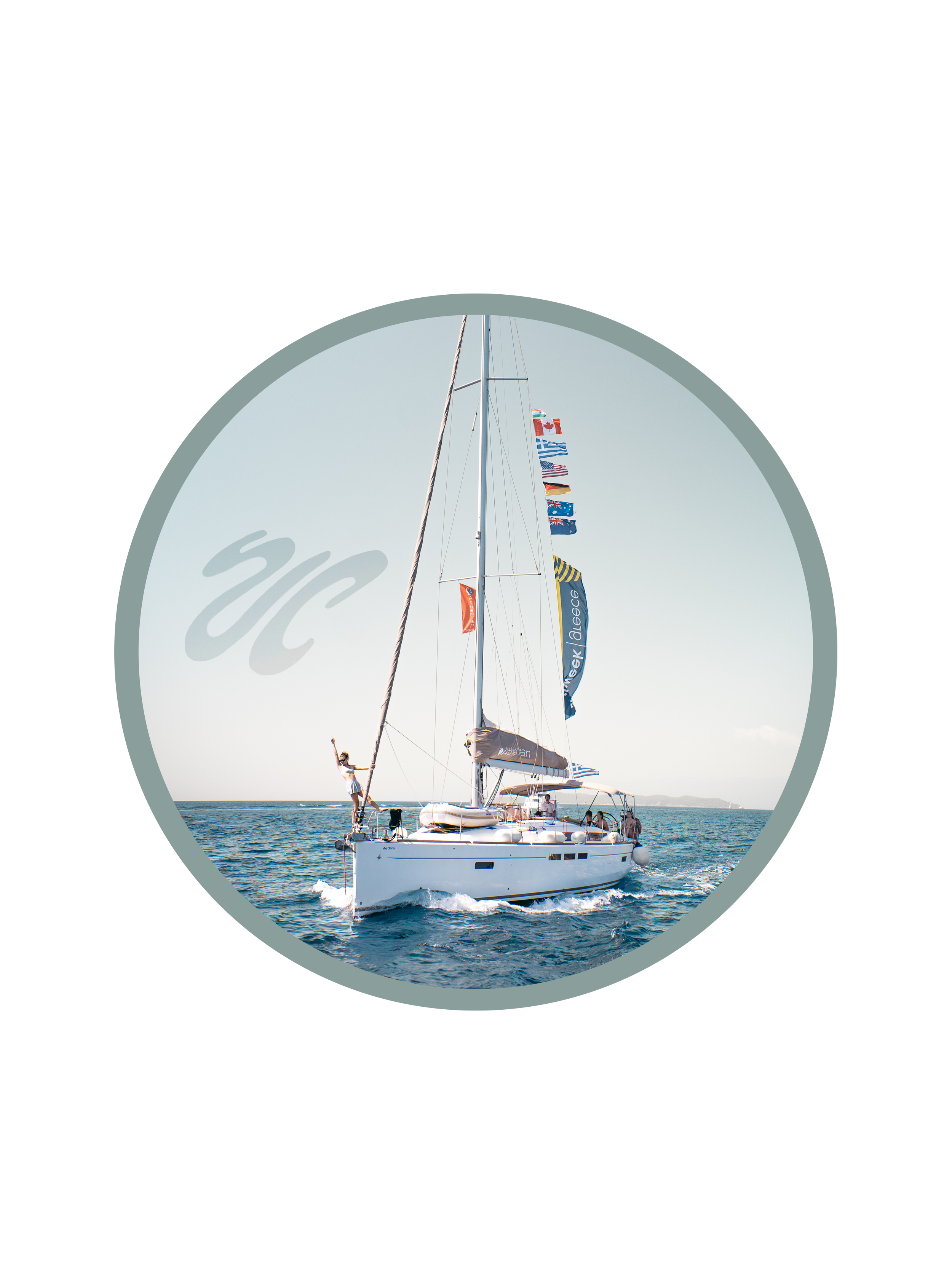 A white sailboat with several flags flying from the mast is moving through the water on a sunny day, with a few people on board.