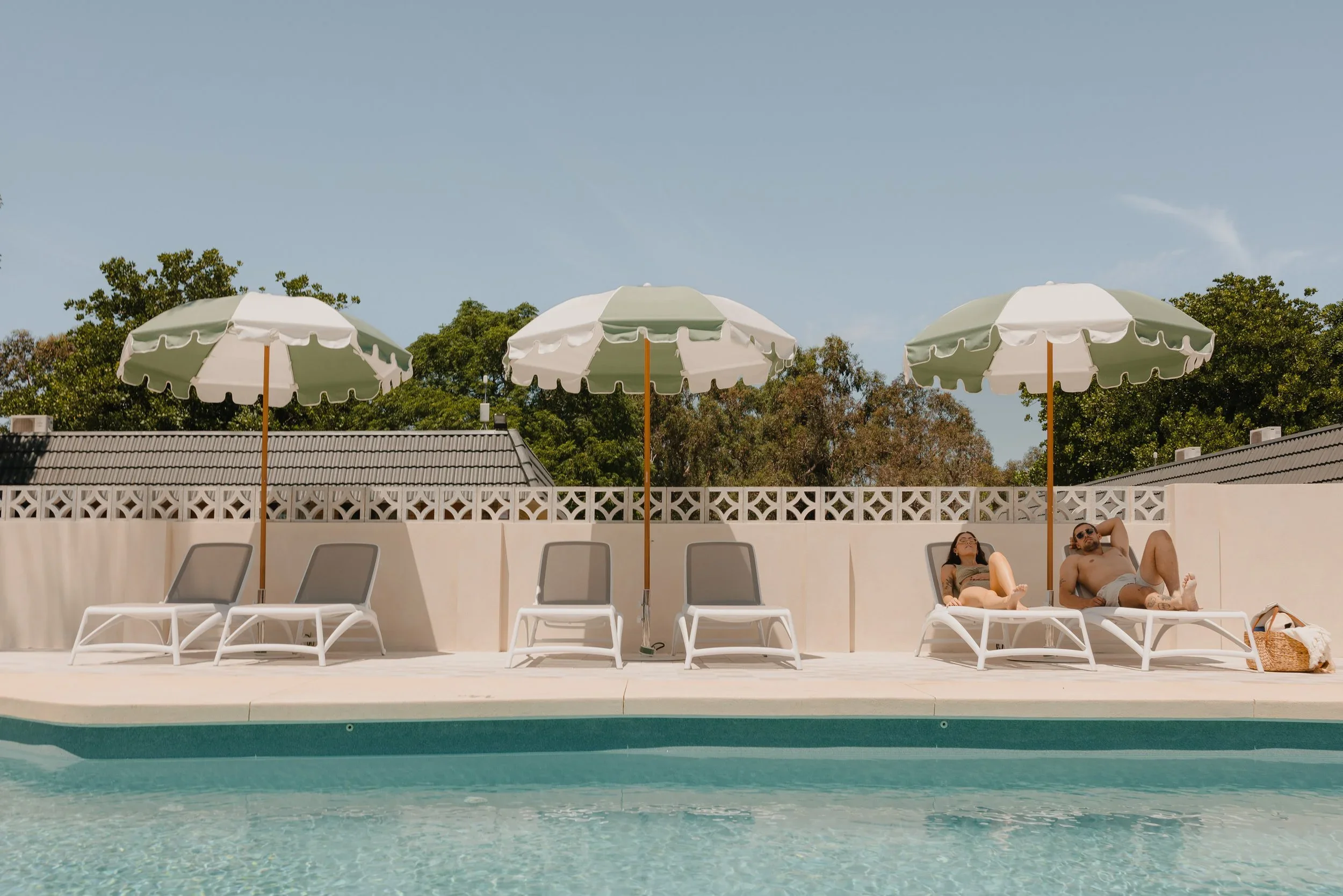 People lazing around the pool at The Timothee