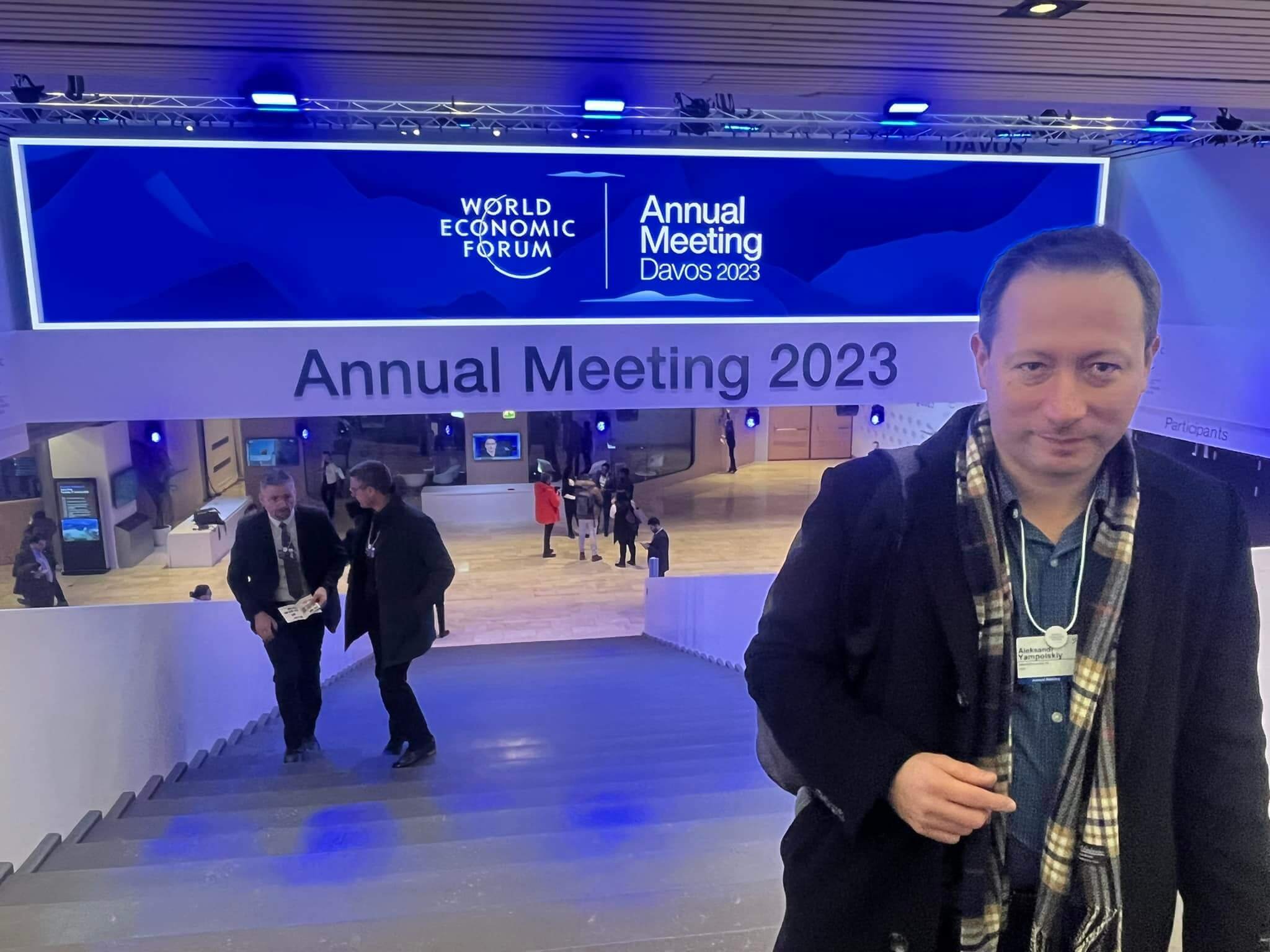 Dr. Aleksandr Yampolskiy | Cybersecurity Expert & CEO of SecurityScorecard standing at the bottom of a staircase at the World Economic Forum Annual Meeting 2023 in Davos, Switzerland.