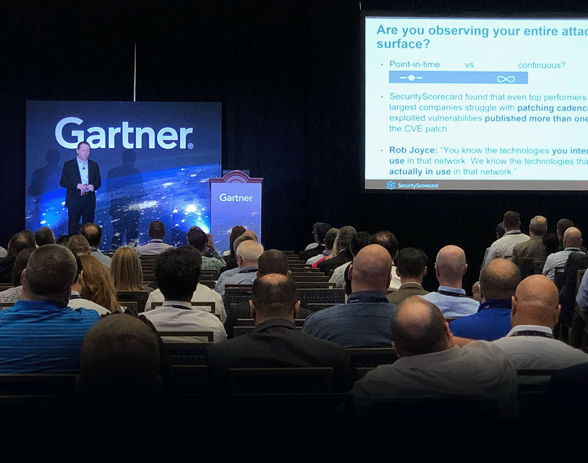 Dr. Aleksandr Yampolskiy | Cybersecurity Expert & CEO of SecurityScorecard standing on a stage at a Gartner conference delivering a talk.