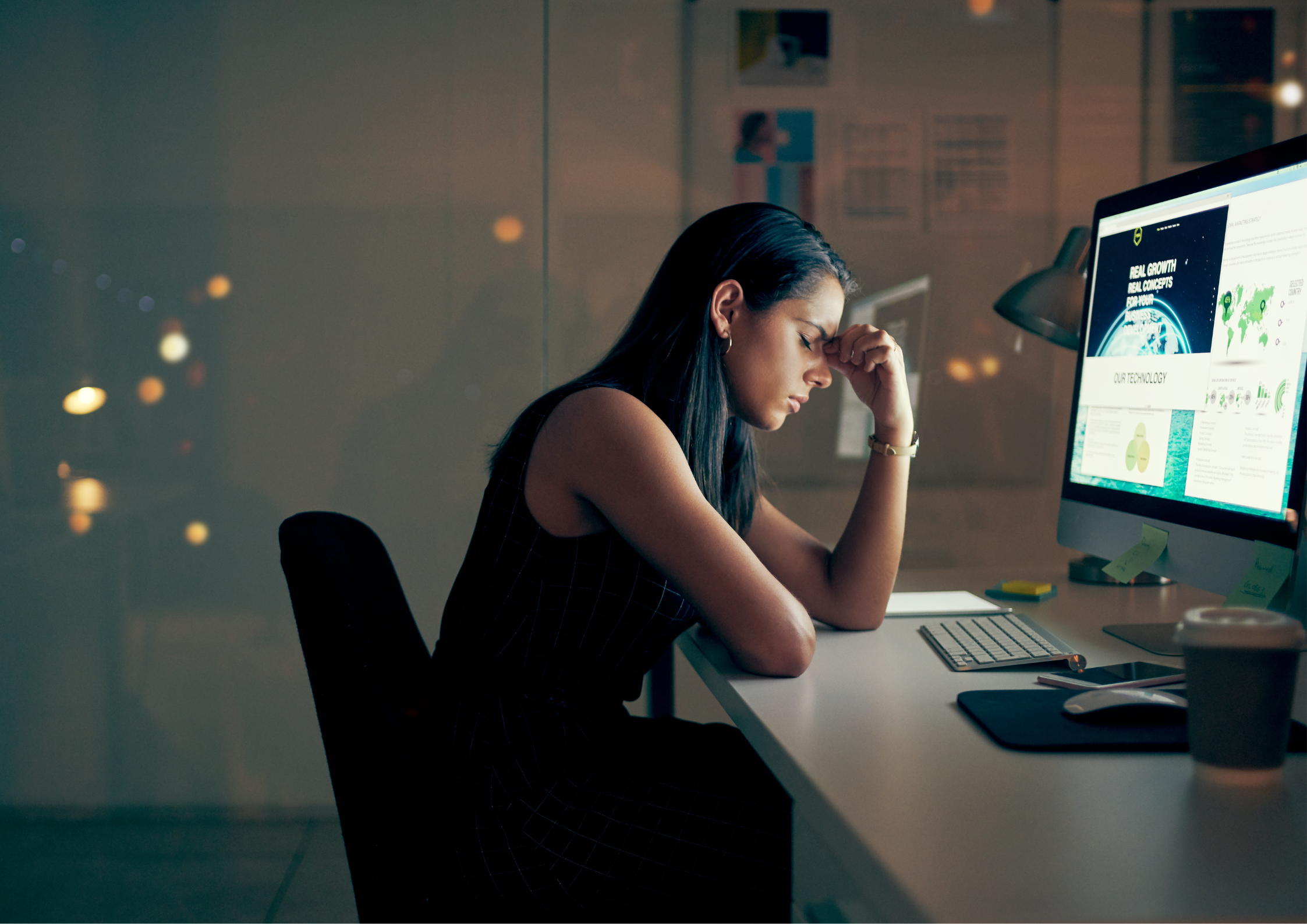 woman sitting on a desk feeling stressed