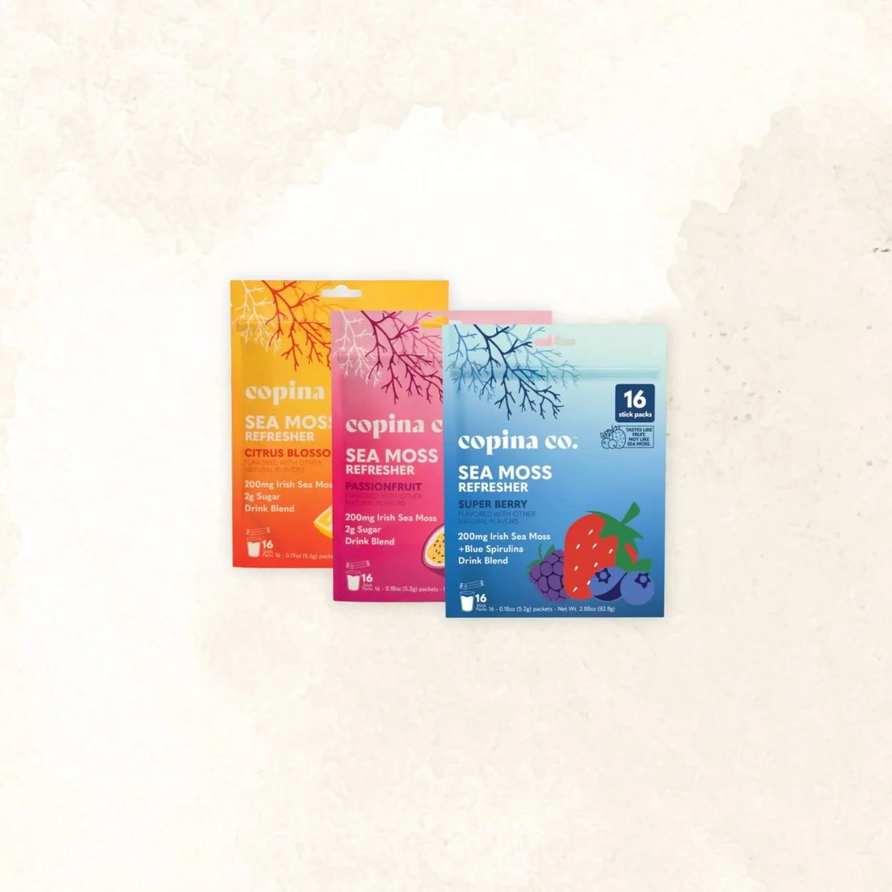 Three packages of Copina Sea Moss Refresher drink packets in citrus blossom, passionfruit, and super berry flavors, arranged on a light surface.