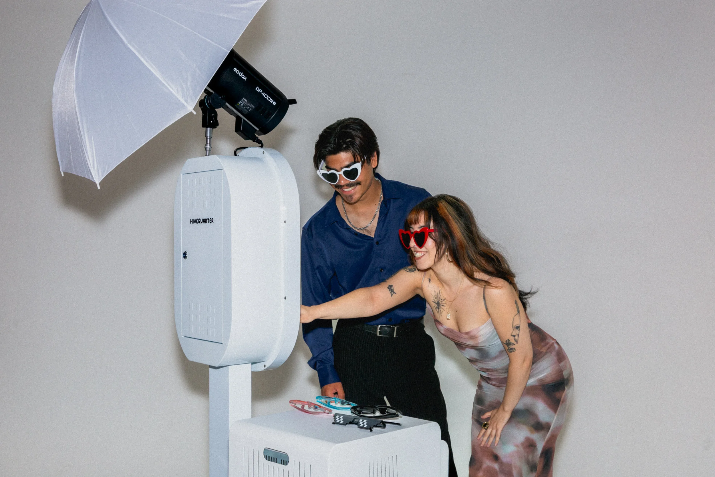 couple using hivequarter booth taking photos