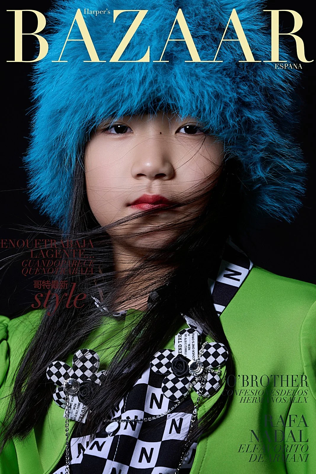Cover of Harper's Bazaar Espana magazine featuring a woman with long black hair wearing a bright green blazer, a black and white checkered shirt, and a fluffy blue hat.