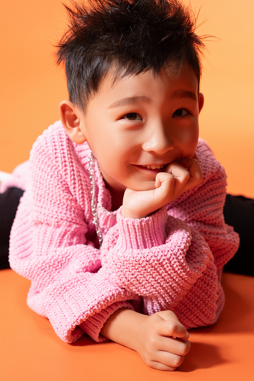 Boy in striped sweater posing for stylish children’s portrait in Queens, NYC
