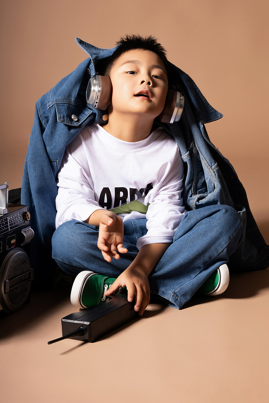 Boy with hands in pockets during casual high-end children’s photoshoot in Queens