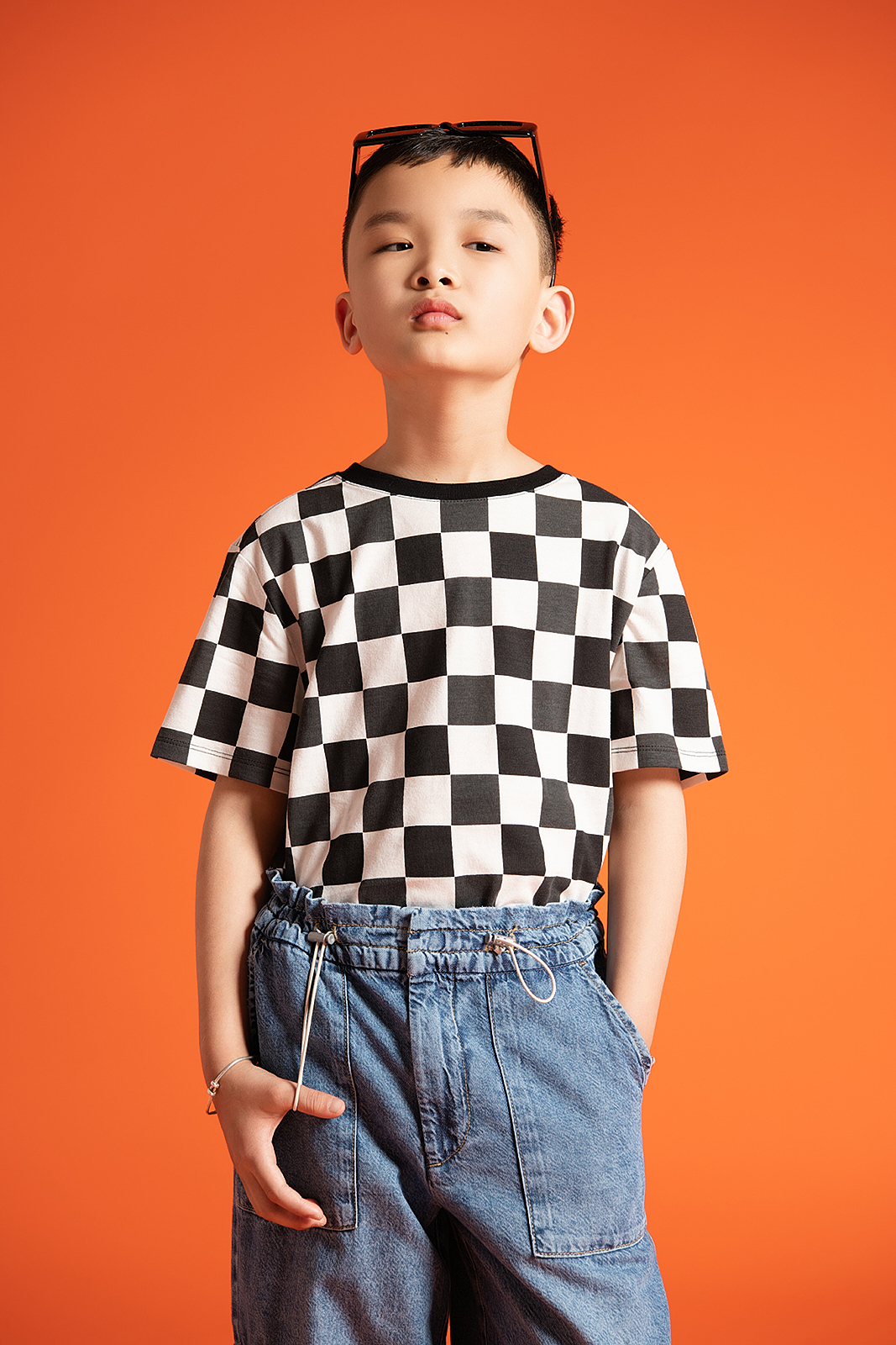 Softly lit studio portrait of young boy in high-end children’s photoshoot