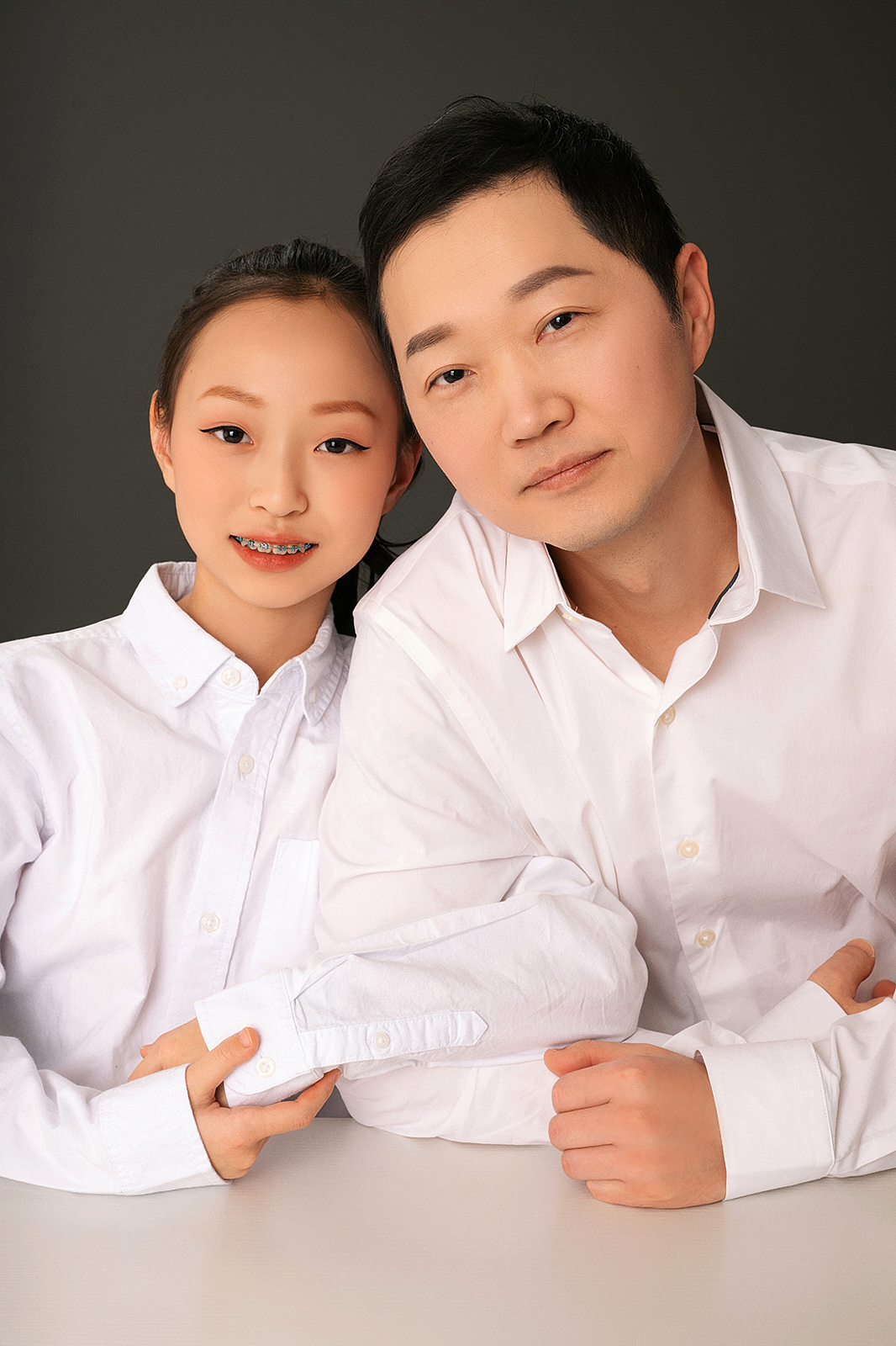 Formal family portrait in Flushing studio with luxury backdrop
