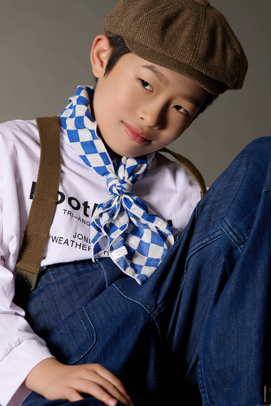 Boy in sailor cap posing for stylish outdoor portrait in Brooklyn              |