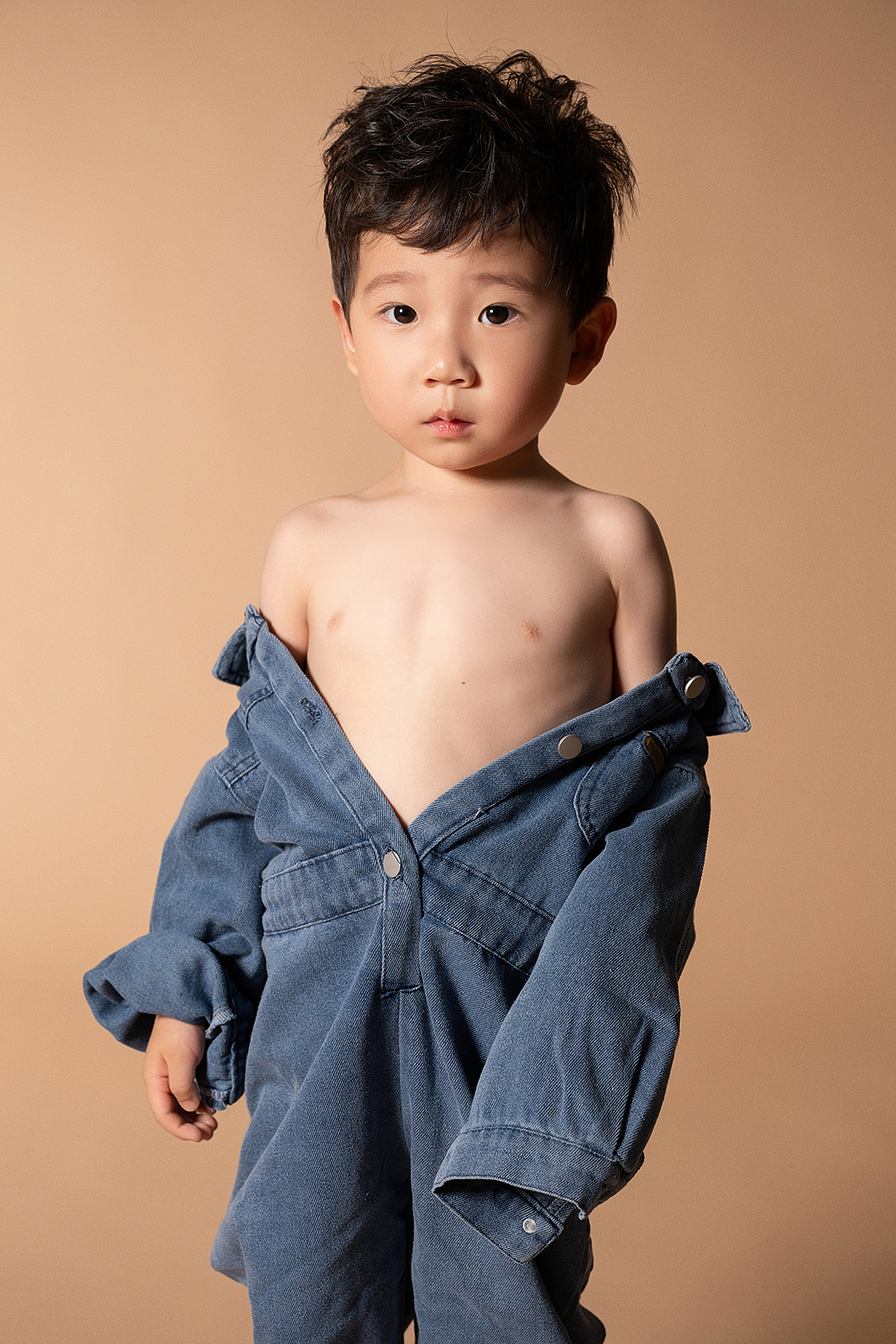 Boy in checkered shirt during playful outdoor photoshoot in Brooklyn park