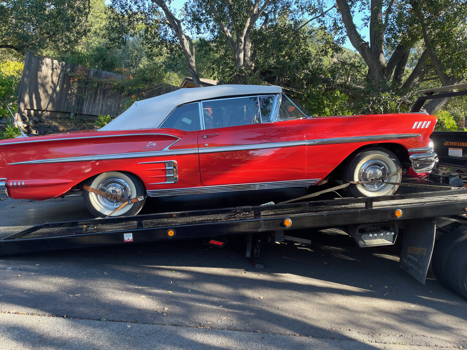 Classic convertible safely transported on a flatbed tow truck in Antioch California by 24-7 Rescue Towing specializing in classic car transport and vehicle towing.