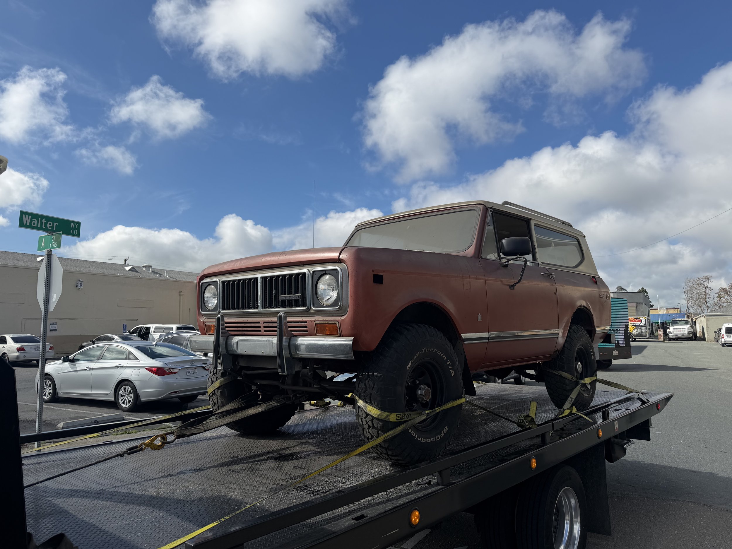 Flatbed towing service transporting classic International Scout in Antioch California