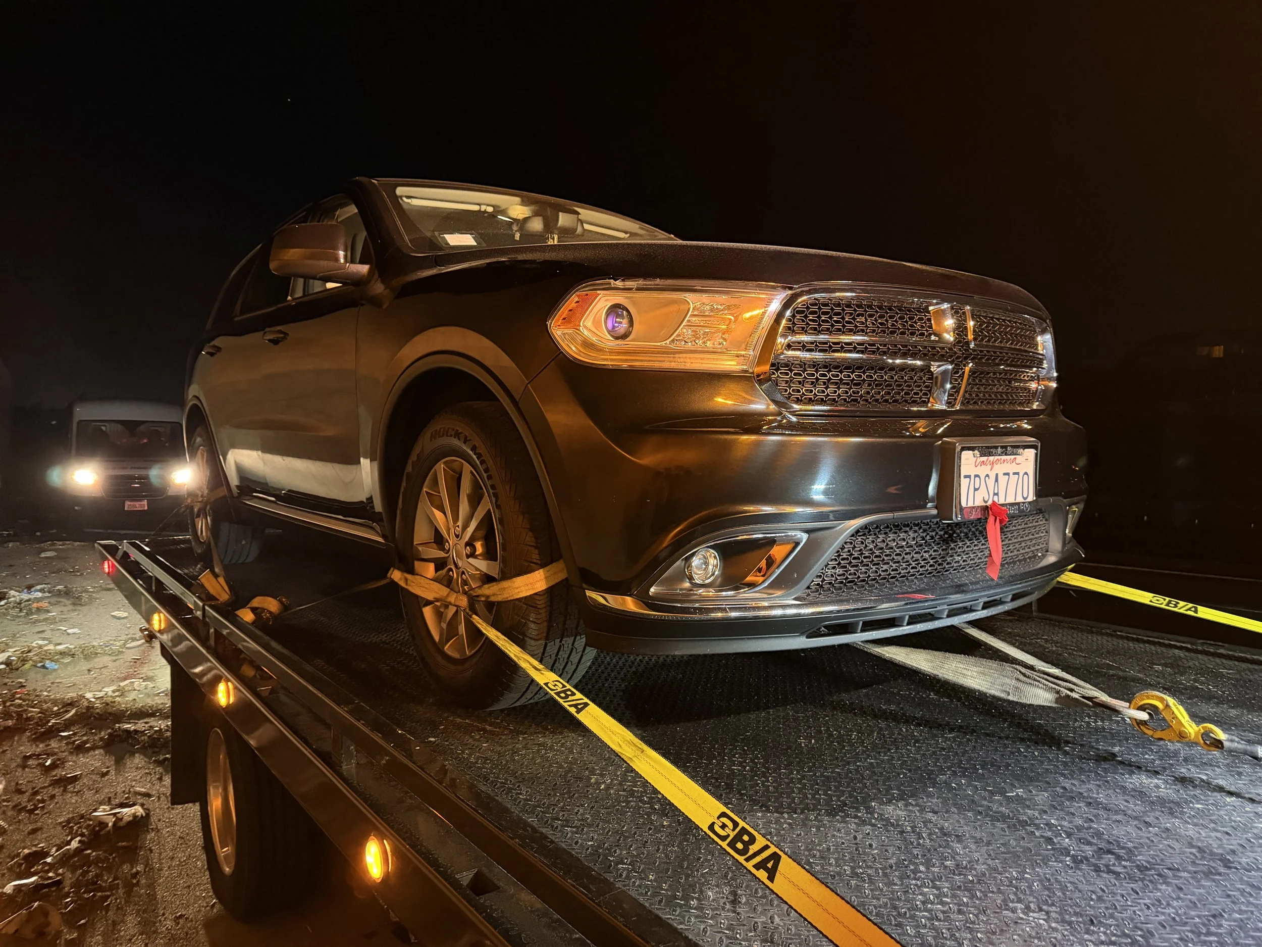 Dodge Durango secured on 24-7 Rescue Towing flatbed during nighttime towing service in Bay Point California