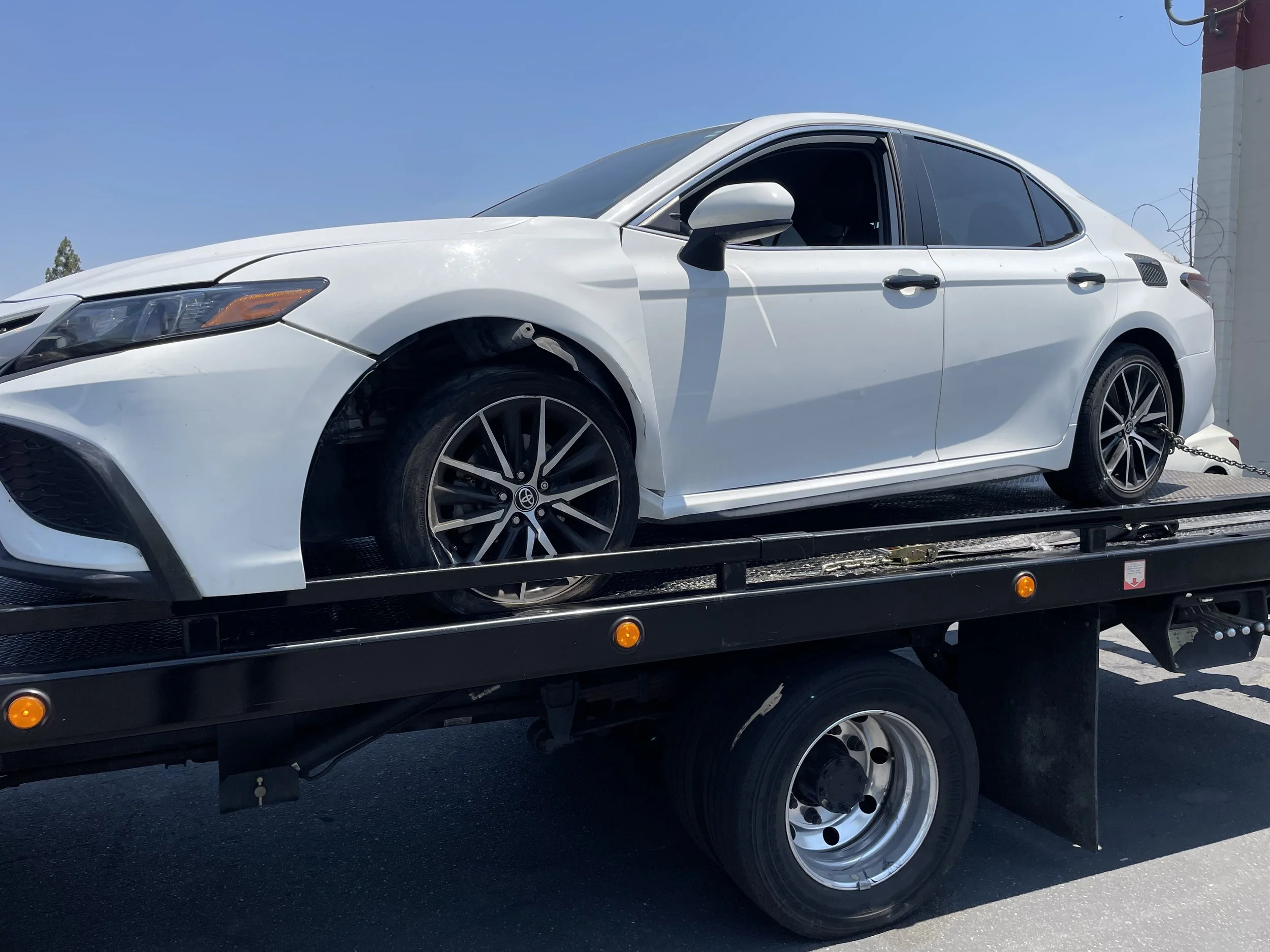 White Honda loaded onto flatbed tow truck in Pittsburg CA