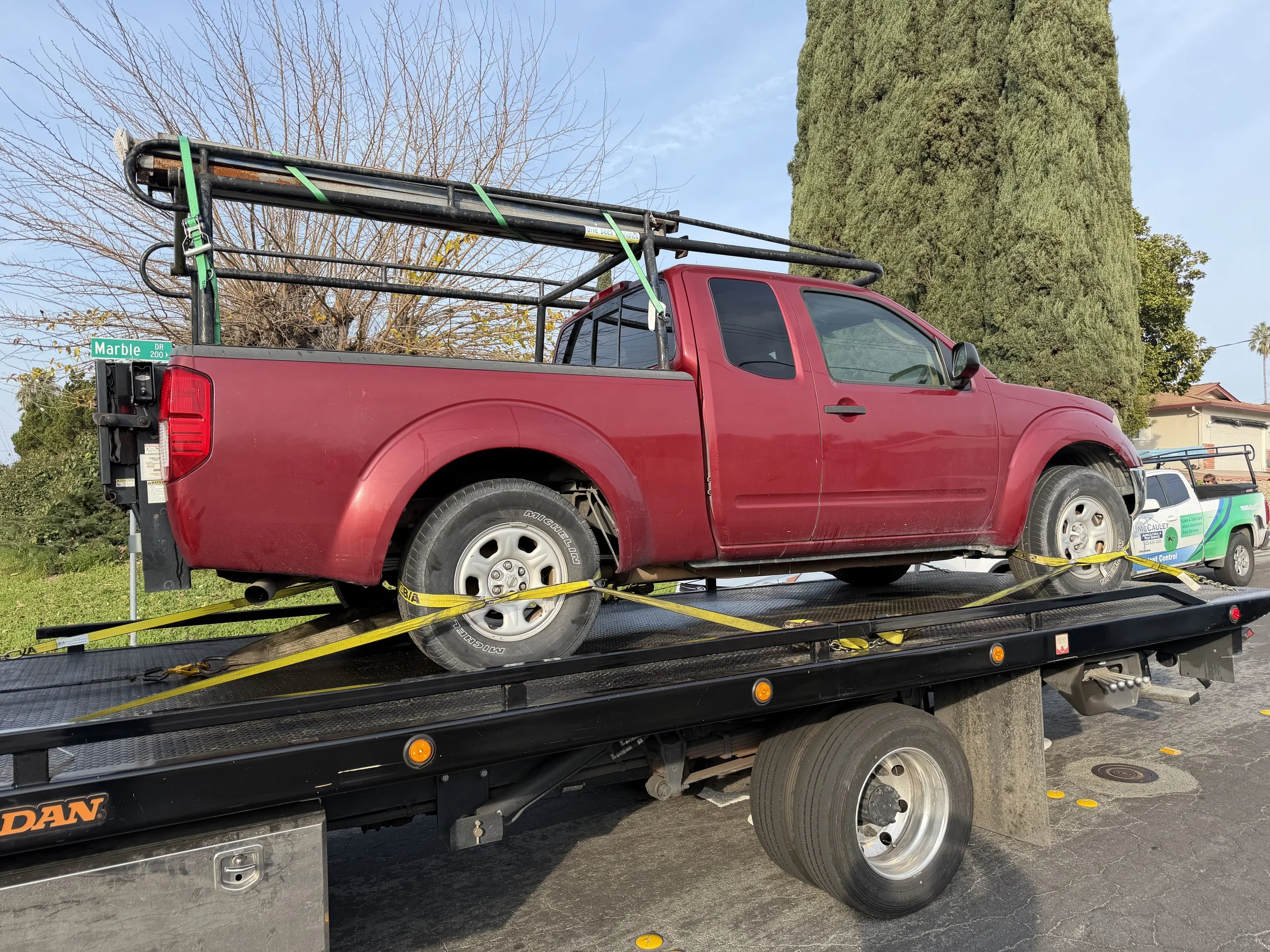 Nissan Frontier pickup truck loaded on flatbed tow truck in Antioch CA