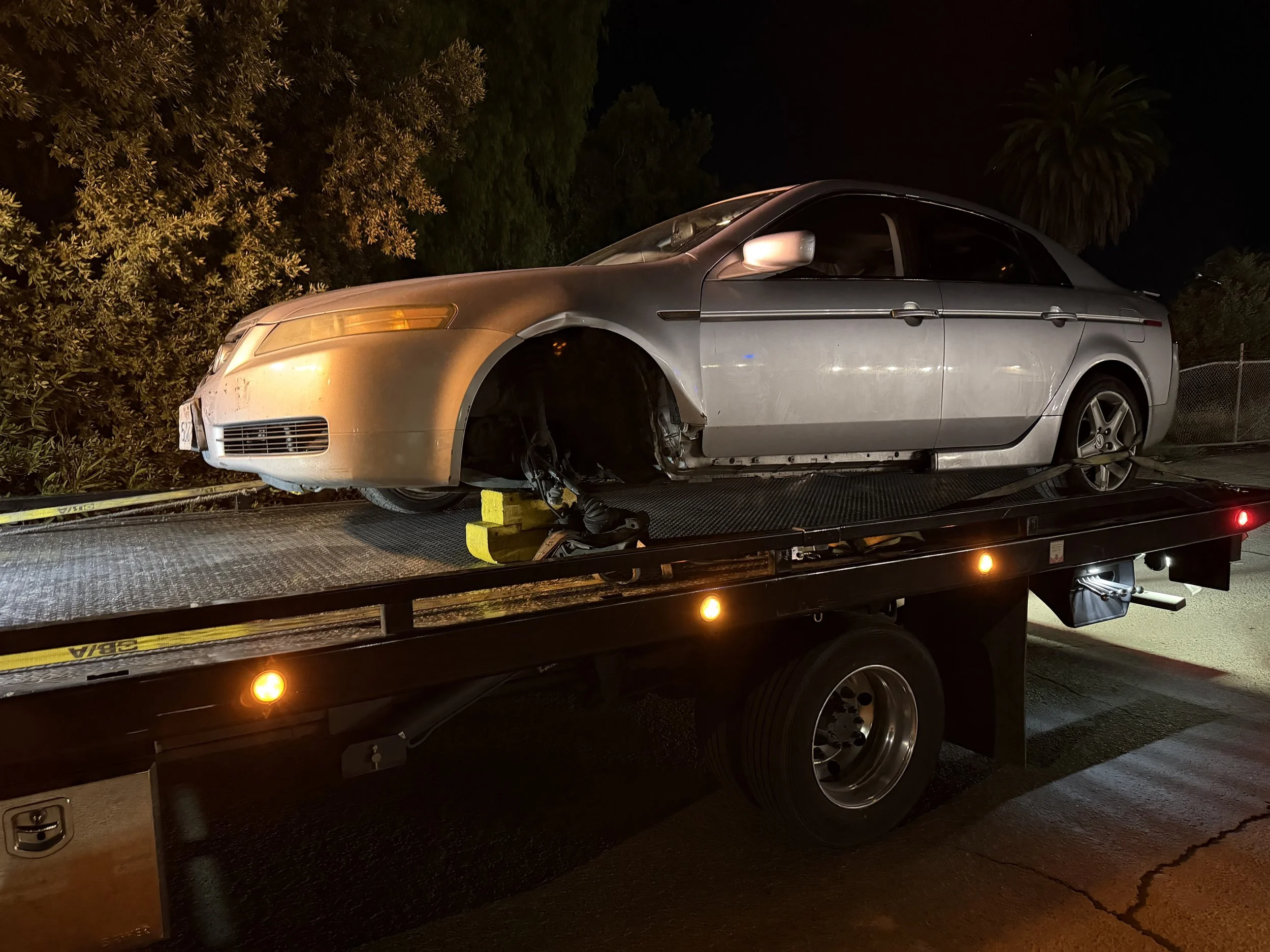 Acura TL with missing wheel being transported by 24-7 Rescue Towing in Bay Point CA