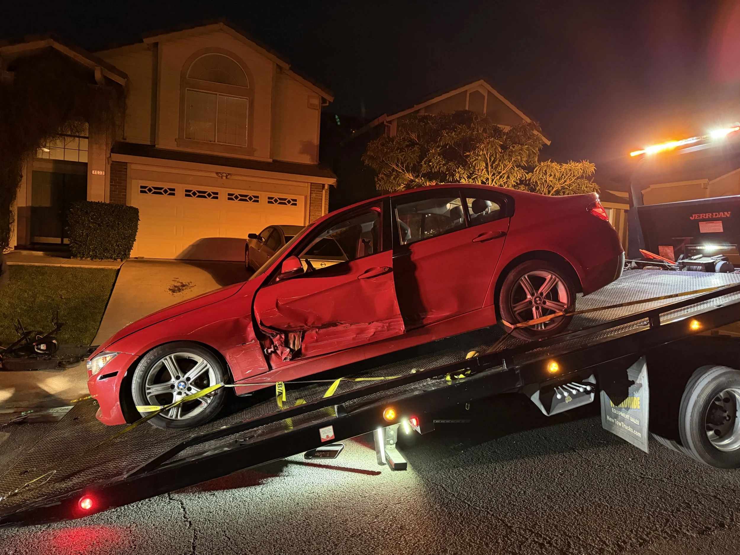 24-7 Rescue Towing providing accident recovery and flatbed towing service for a damaged BMW sedan in Antioch, California.