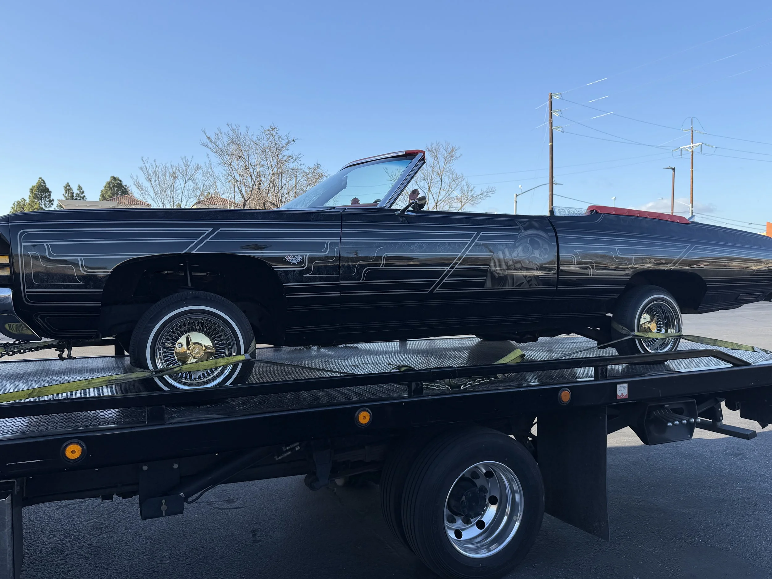 Classic lowrider convertible transported on a flatbed tow truck by 24-7 Rescue Towing in Antioch CA.