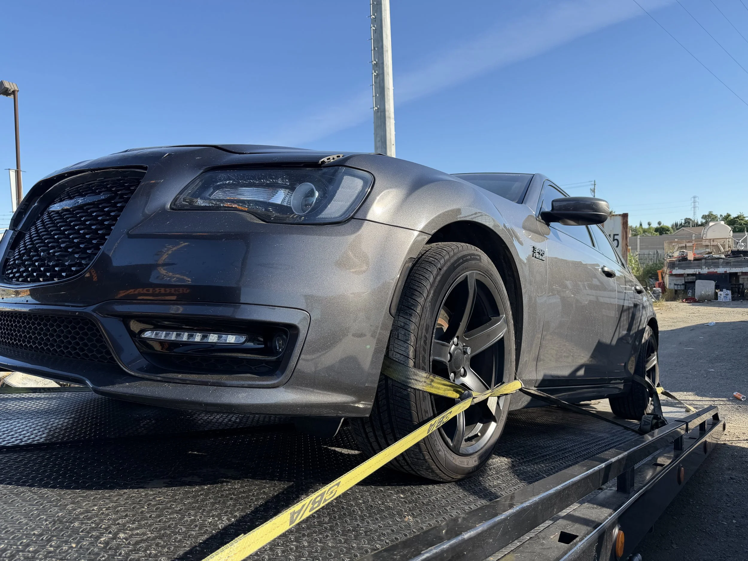 Chrysler 300 being transported by 24-7 Rescue Towing flatbed service in Bay Point CA