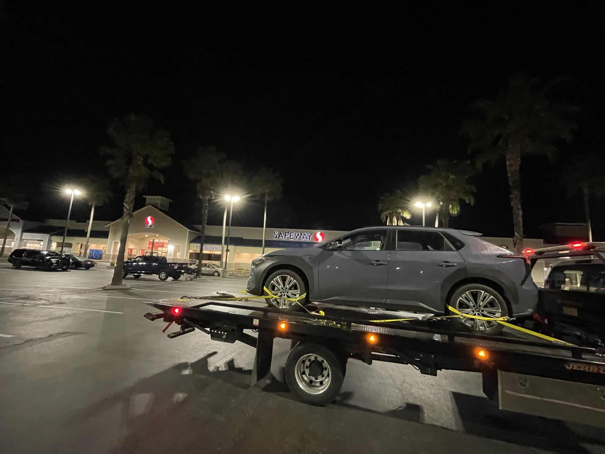 24-7 Rescue Towing providing nighttime flatbed towing service at Safeway in Discovery Bay, CA