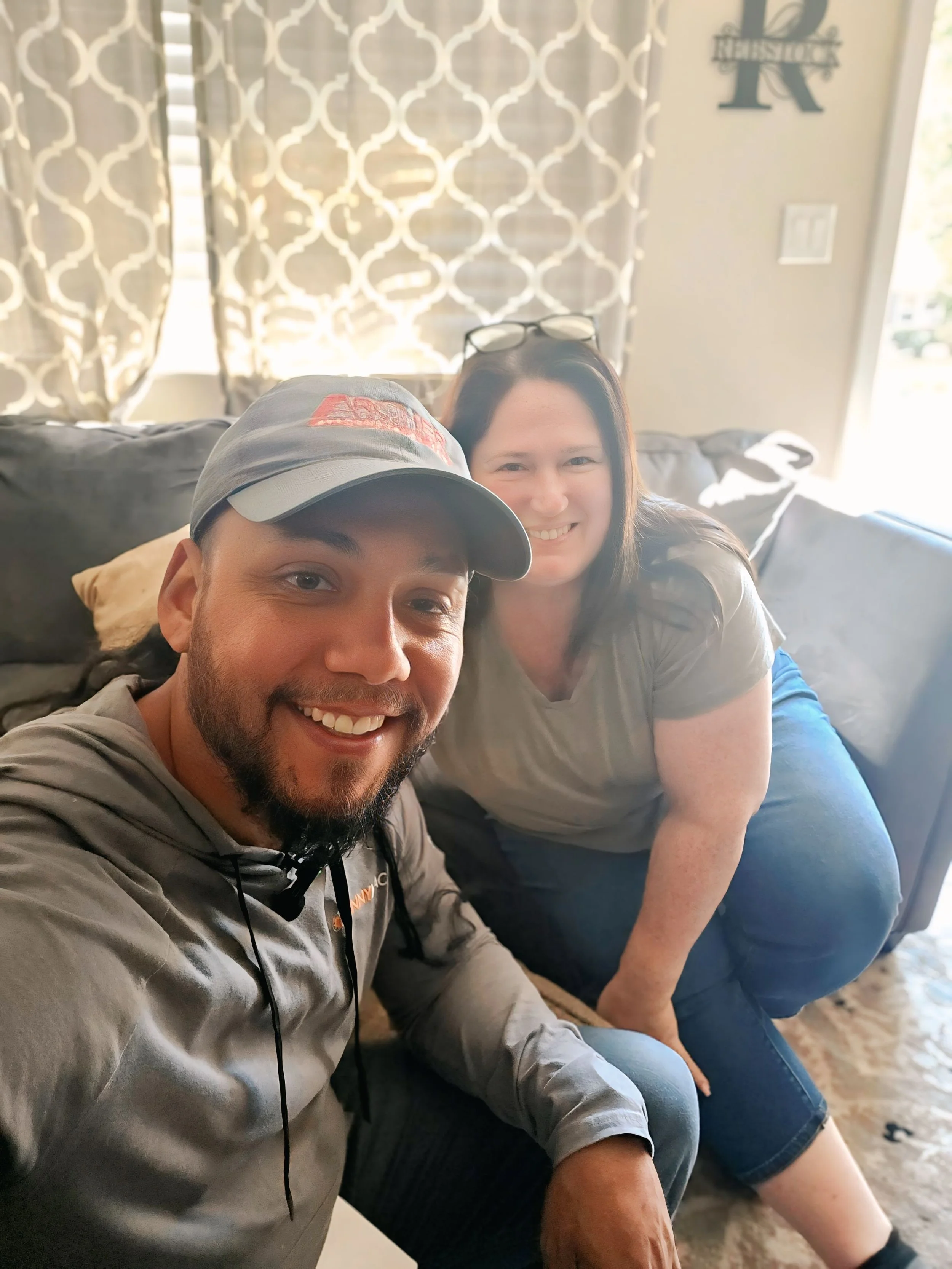 Jose the Sun Hunter meeting with a homeowner inside their NJ home to discuss solar program options. Smiling faces and a relaxed setting highlight personalized service and client trust in clean energy solutions.