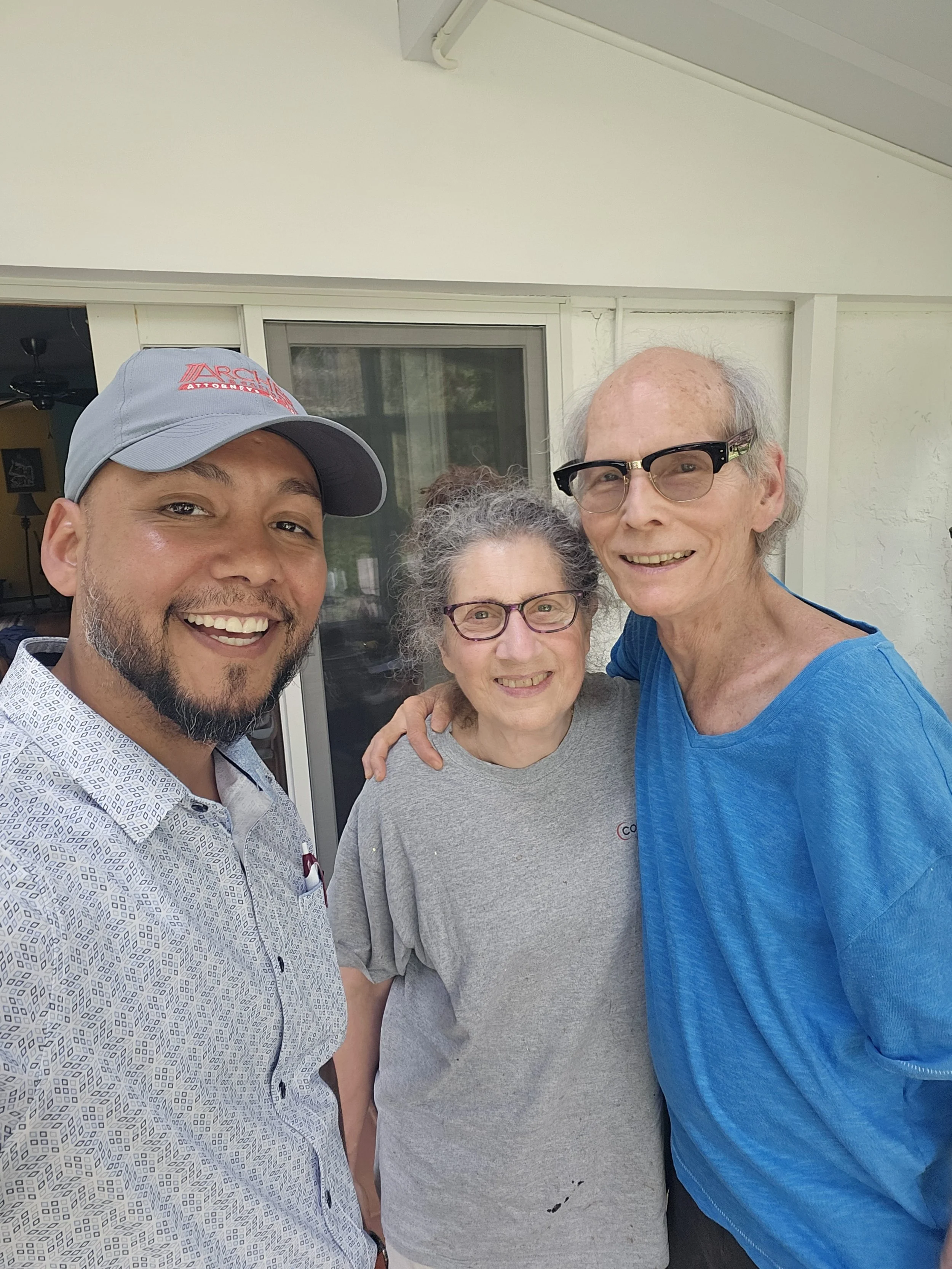 Jose the Sun Hunter smiling with an elderly couple outside their NJ home after a solar consultation. Happy customers represent trust, personalized service, and the benefits of going solar for homeowners of all ages.