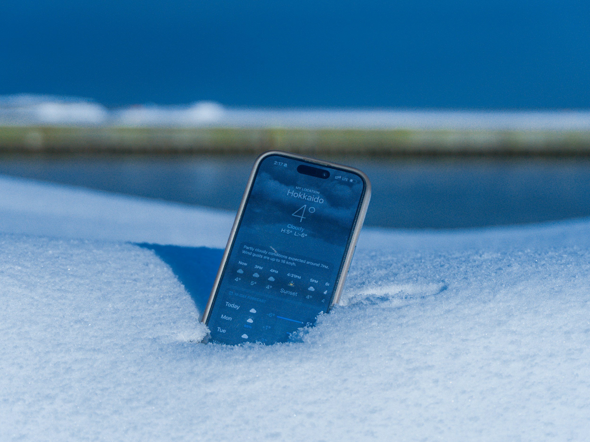 Smartphone half-buried in snow displaying a way to access the Lakeview Fellowship media archive (even in the winter time!).