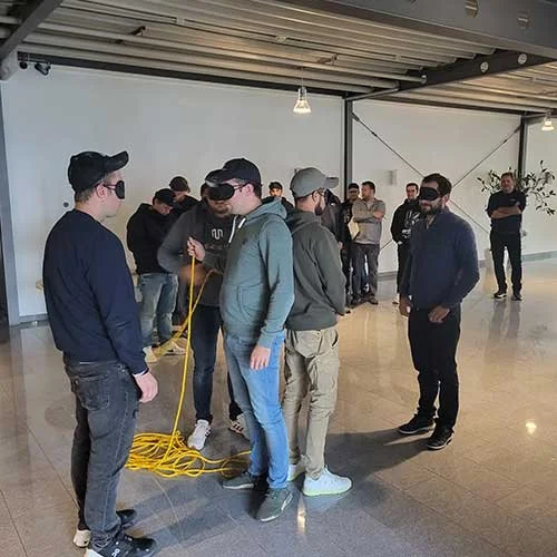 Gruppe von Menschen in einem Raum, einige tragen VR-Brillen, andere stehen in einer Reihe.