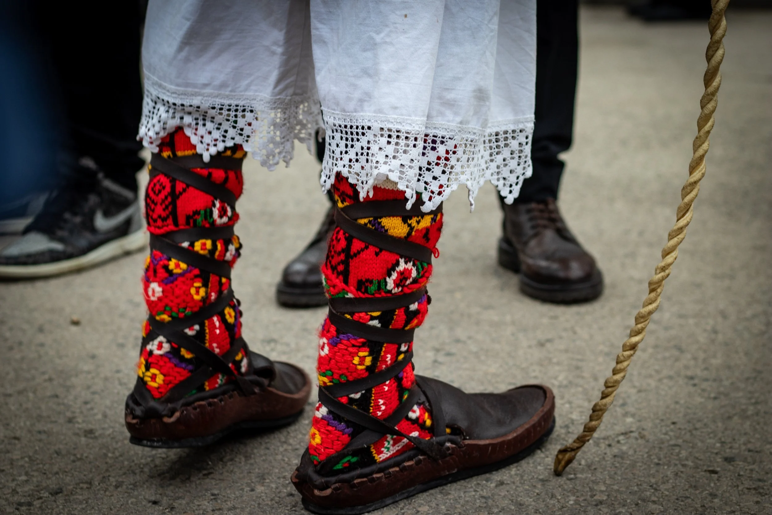 Close-up of colourful Busó socks with pom-poms during Busójárás winter carnival