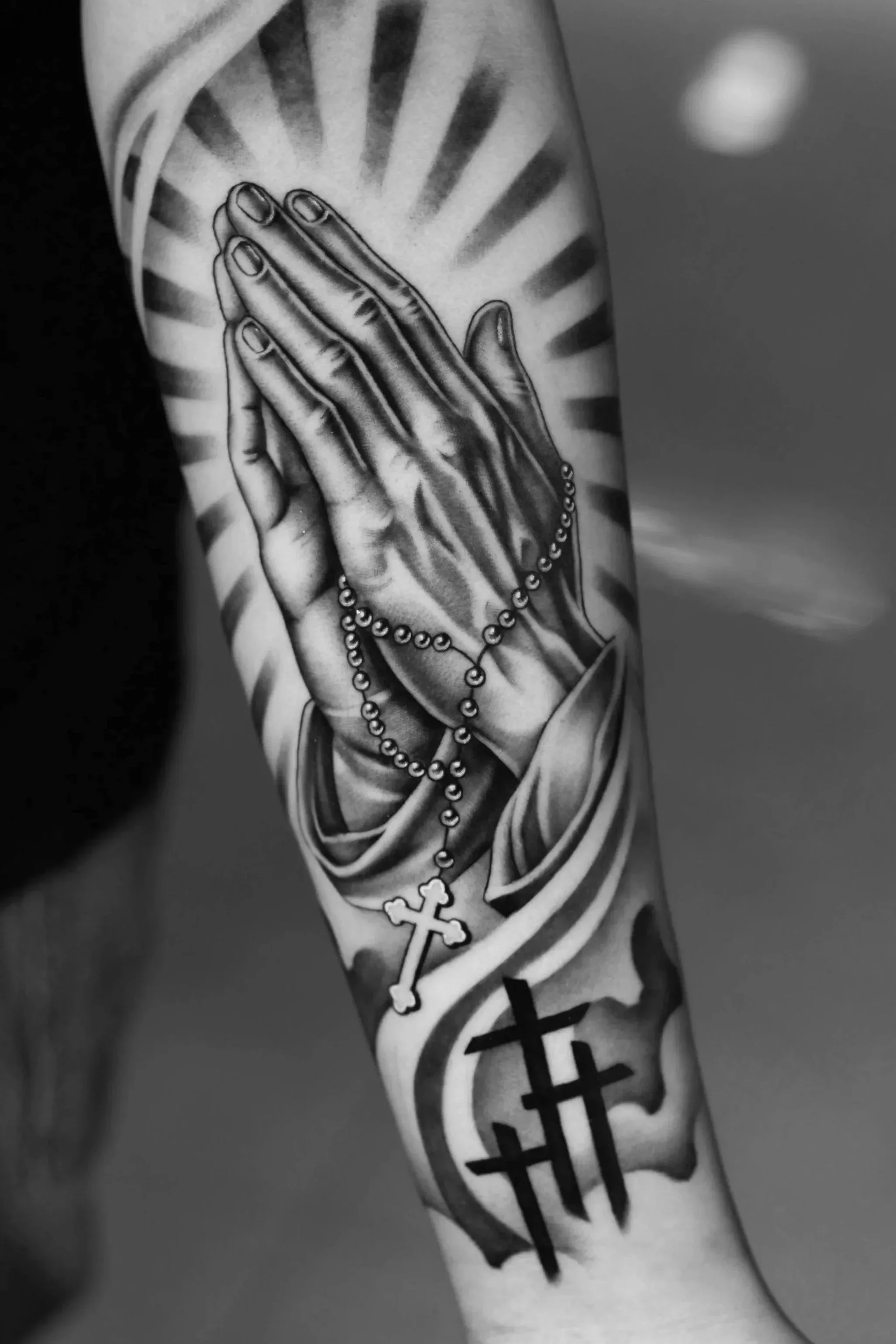 Praying hands tattoo with rosary