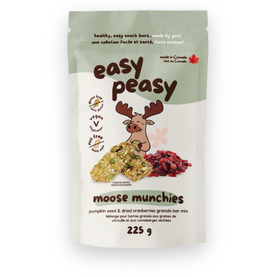 Front of a green and white package of Easy Peasy Moose Munchies pumpkin seed and dried cranberries granola bar mix, featuring cartoon moose, with images of granola bars and dried cranberries, and text indicating it is gluten-free, vegan, nut-free, made in Canada, and contains 225 grams.
