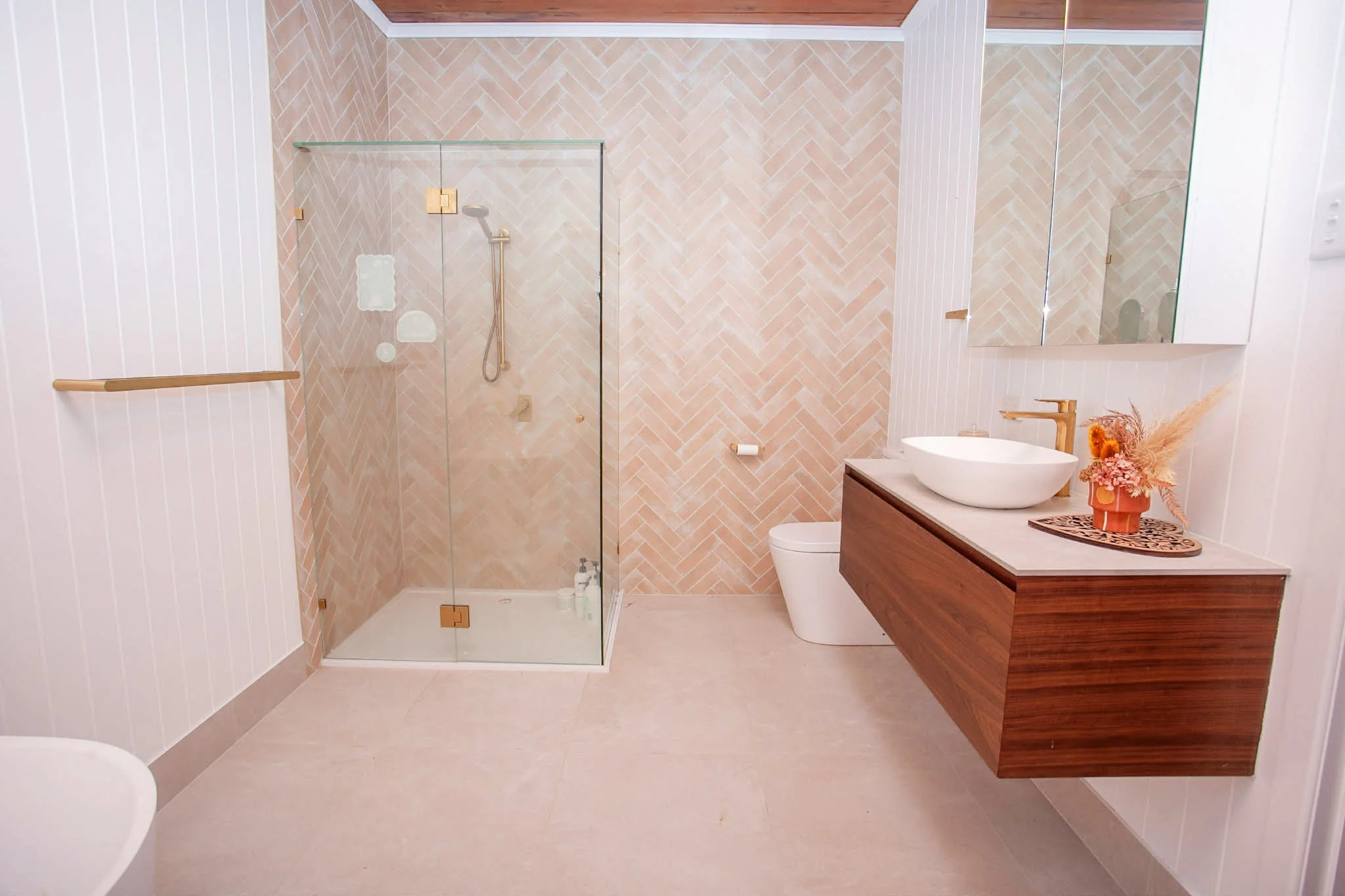 A newly renovated bathroom with a tiled feature wall.