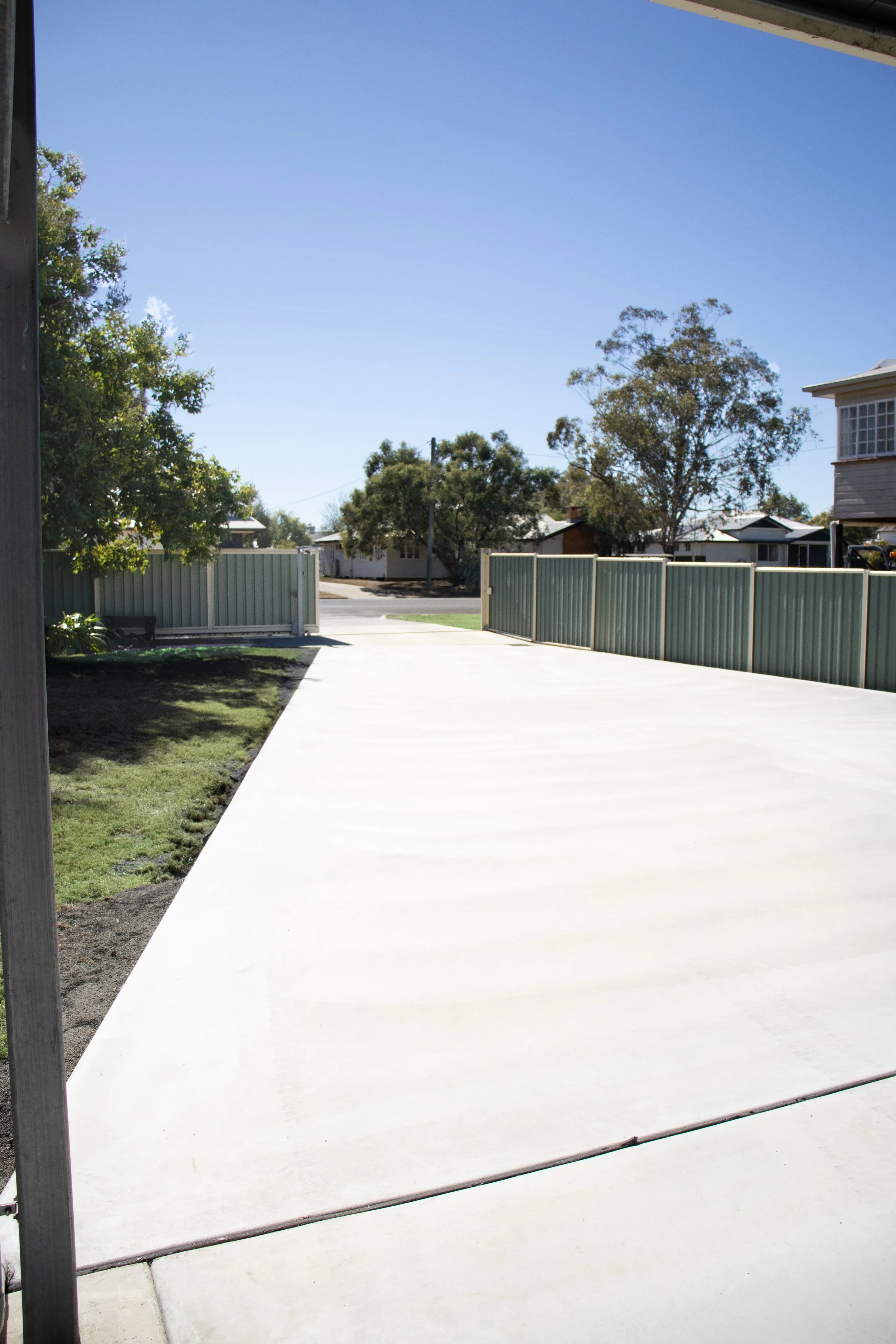 Concrete driveway extending from shed to street kerb.