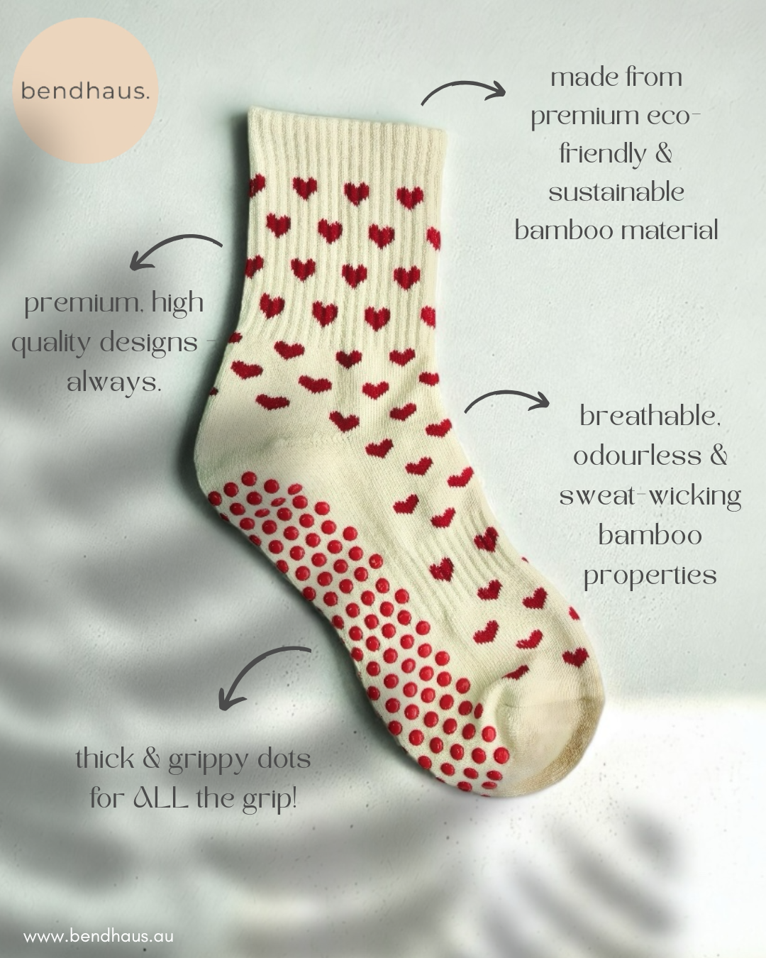 A white sock with red heart patterns and red grip dots, made from eco-friendly bamboo material. The image includes text highlighting the sock's eco-friendliness, high-quality design, breathability, and grip-enhancing dots.