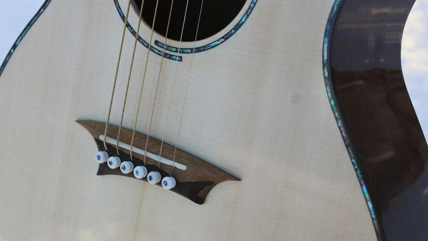 Close-up of the Snowbird guitar’s abalone rosette and soundhole detail.