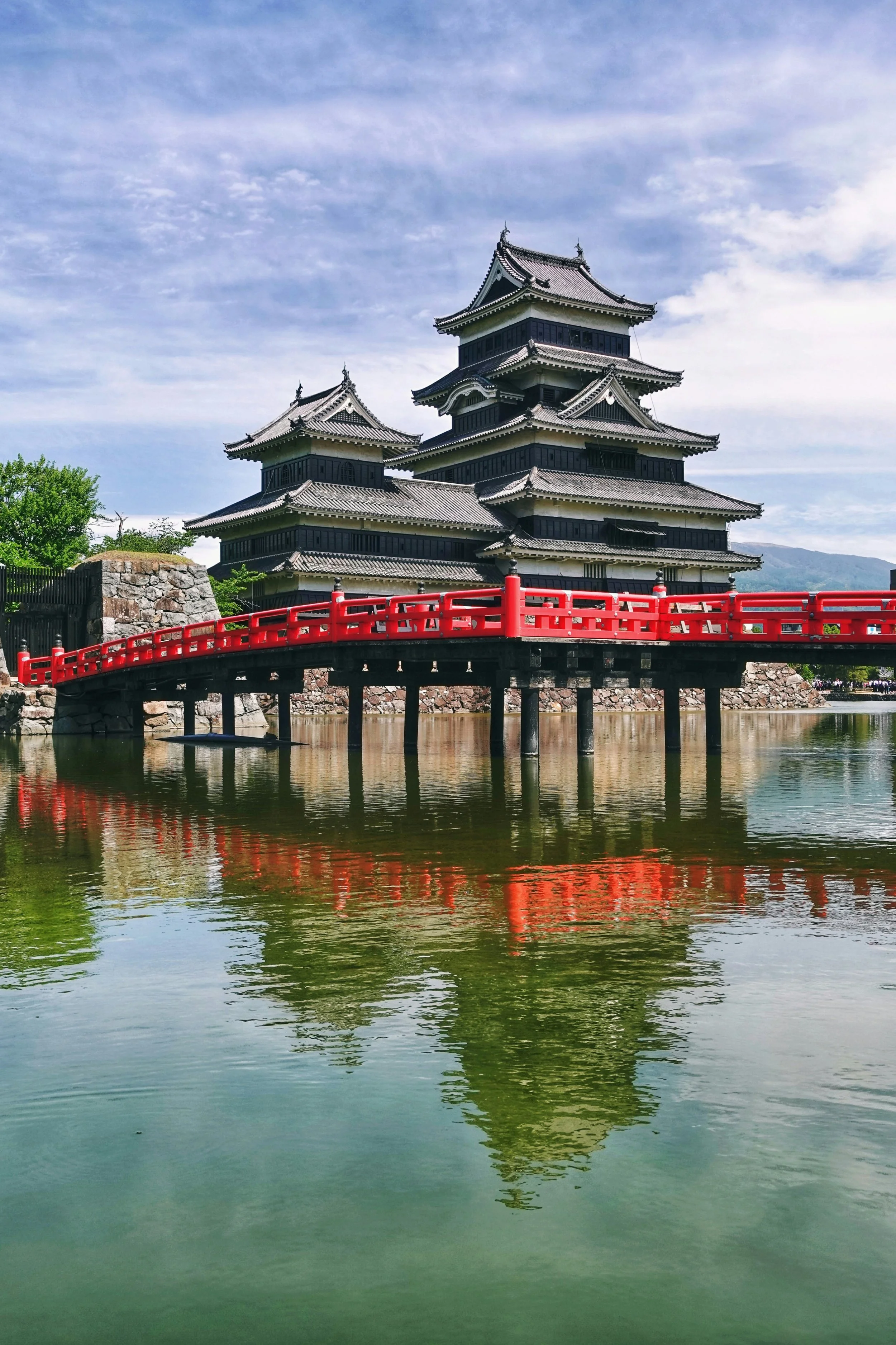 Matsumoto Castle with red bridge over the moat in Nagano