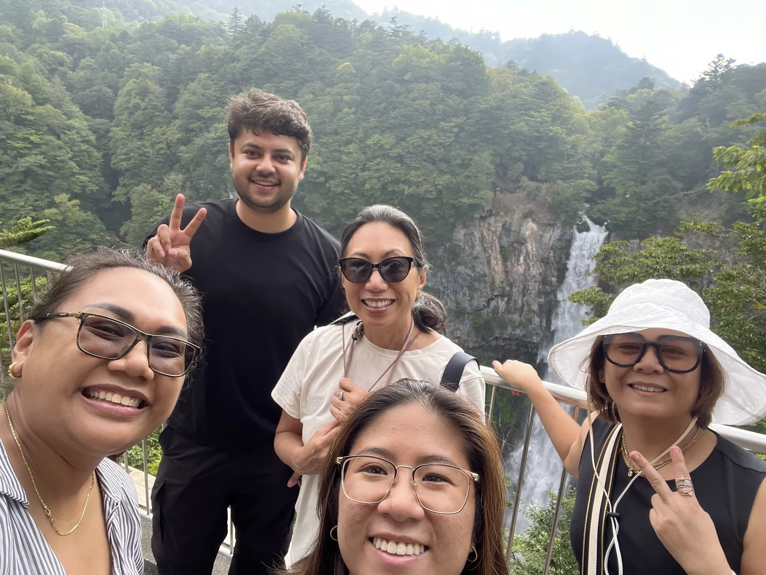 Nikko private day tour guests beside a mountain waterfall
