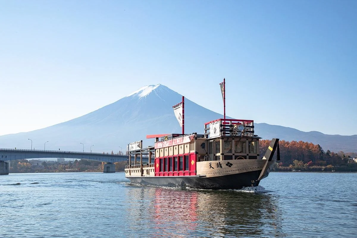 Sightseeing boat on Lake Kawaguchi with Mount Fuji behind